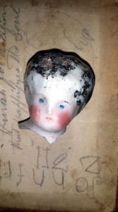 An excavated antique china doll's head. From http://alteredbits.com/vintage-dolls-doll-parts.php