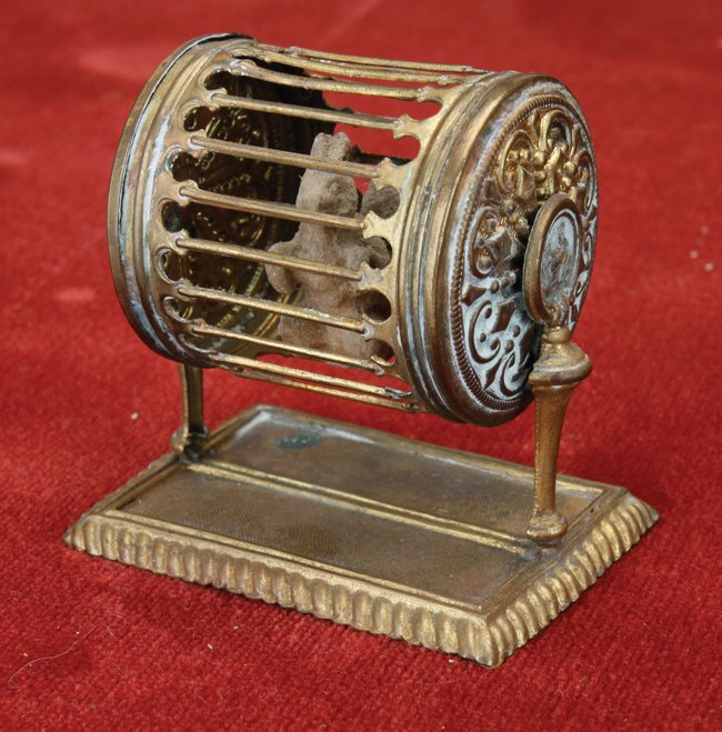 A miniature ormolu squirrel cage. http://www.liveauctioneers.com/item/25105993_erhard-and-sohne-squirrel-cage