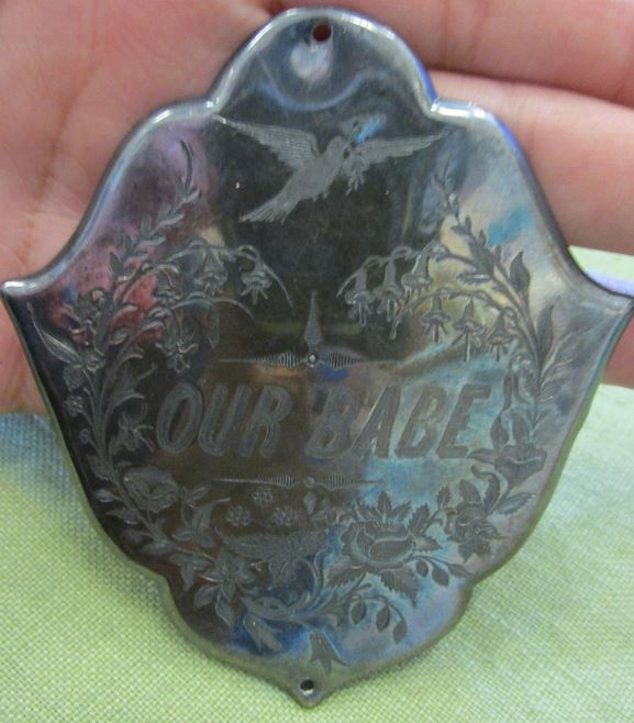 "Our Babe" coffin plate. http://www.ebay.com/itm/RARE-Antique-Victorian-Funeral-Coffin-Casket-OUR-BABE-Silver-Plate-Plaque-/311420971897?