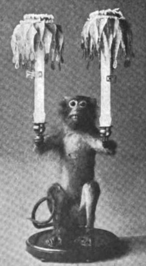 Pet monkey holding candelabra